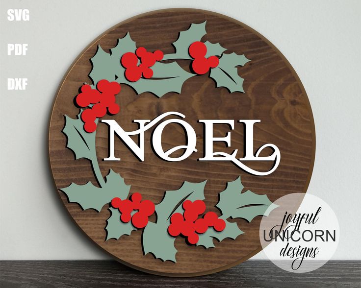 a wooden sign with holly leaves and the word noel on it