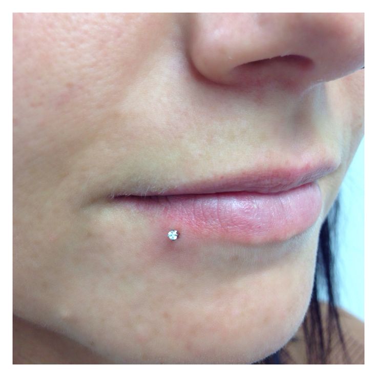 a woman's nose with a small diamond in the middle of her left lip