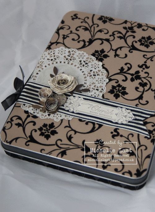 a small box with flowers and lace on it