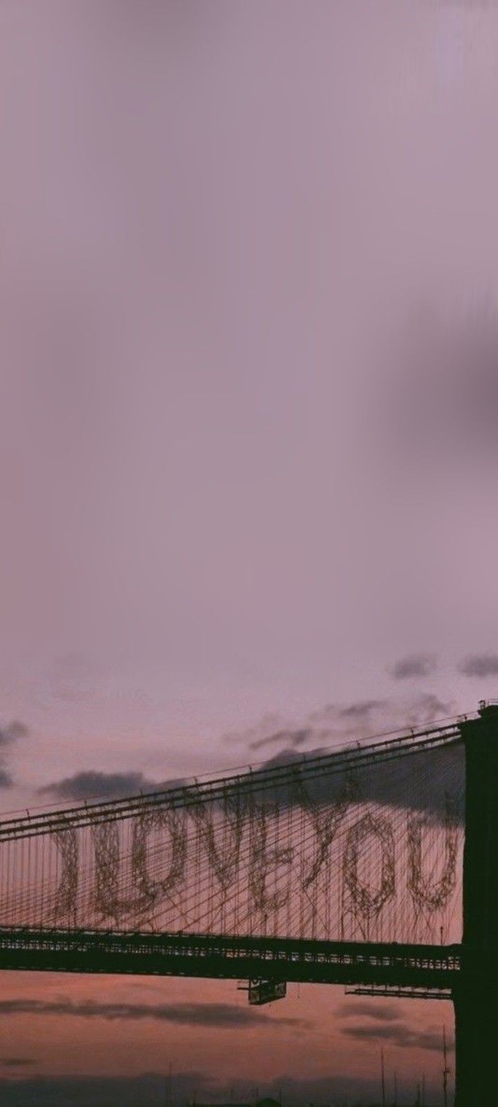 a bridge with graffiti written on it and the sky in the backgrouds