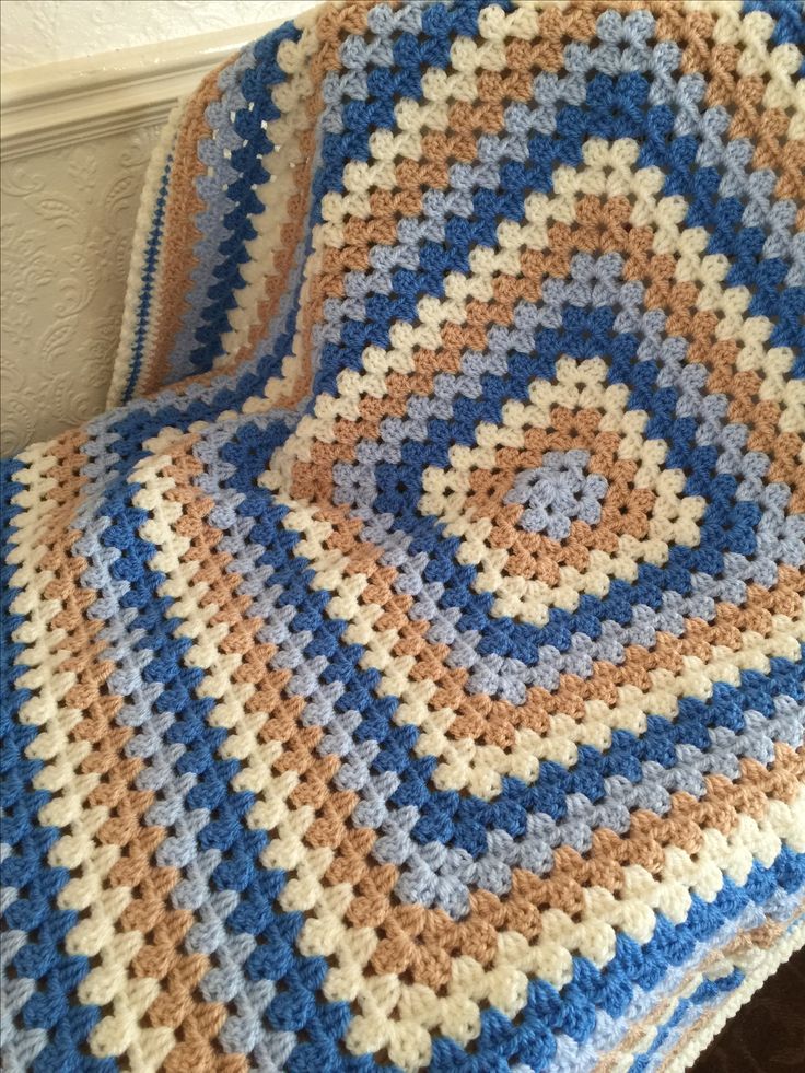 a crocheted blanket sitting on top of a chair