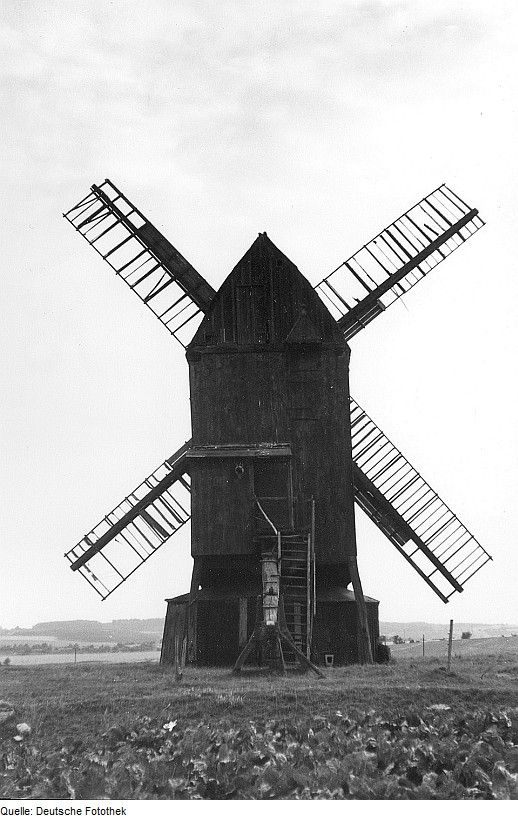 an old black and white photo of a windmill