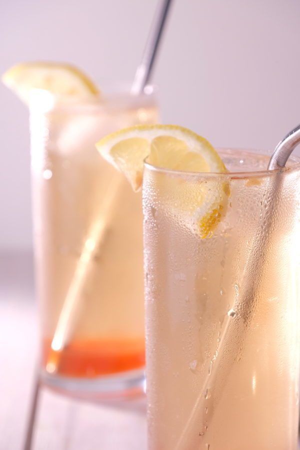 two glasses filled with ice and lemon slices