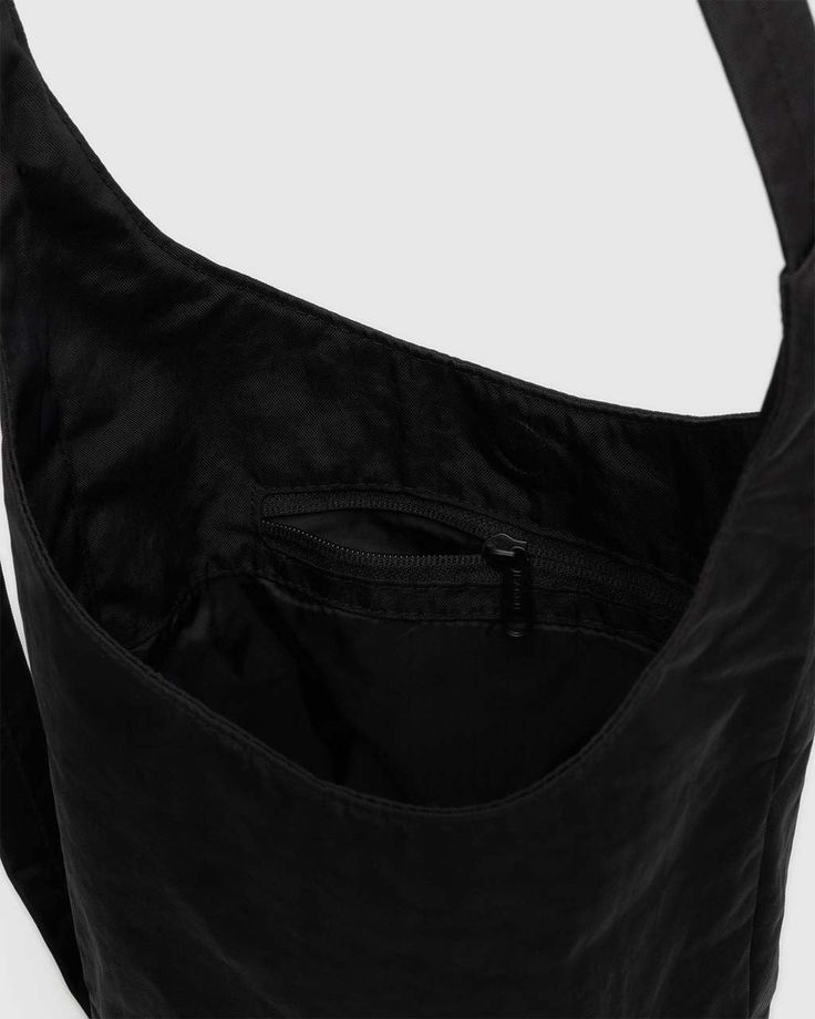 A slouchy, softly structured nylon bag with an adjustable strap. Interior zip pocket with a magnetic closure. The details- Heavyweight nylon (59% recycled) 9.5 in. H × 7 in. W × 4.25 in. D 39 in. adjustable strap Machine washable Black Nylon Hobo Bag With Adjustable Strap, Functional Nylon Shoulder Bag With Adjustable Straps, Nylon Crossbody Hobo Bag With Zipper Closure, Functional Nylon Hobo Shoulder Bag, Nylon Hobo Shoulder Bag With Zipper Pocket, Functional Nylon Hobo Bag With Removable Pouch, Functional Nylon Hobo Bag, Practical Nylon Shoulder Bag With Adjustable Strap, Functional Nylon Hobo Bag With Adjustable Strap