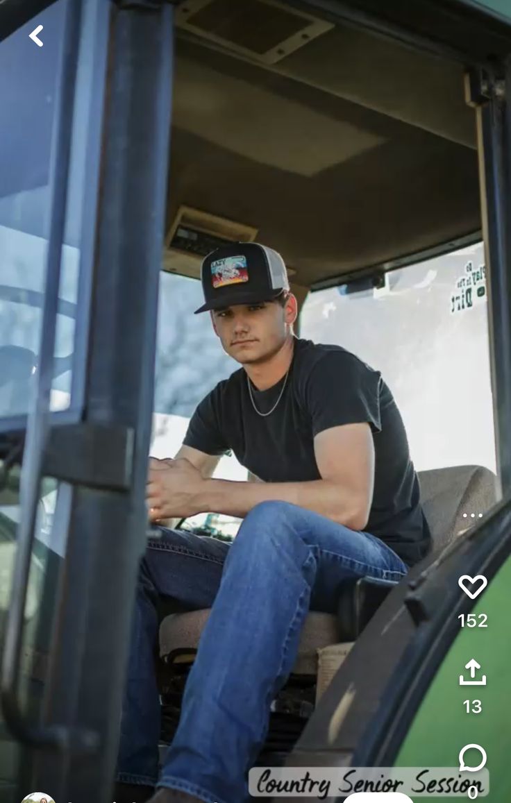 a man sitting in the driver's seat of a tractor