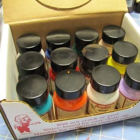 a box filled with lots of different colored bottles