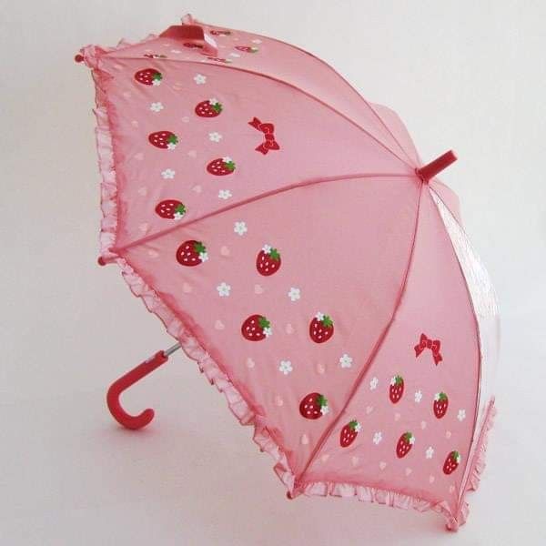 a pink umbrella with strawberries on it