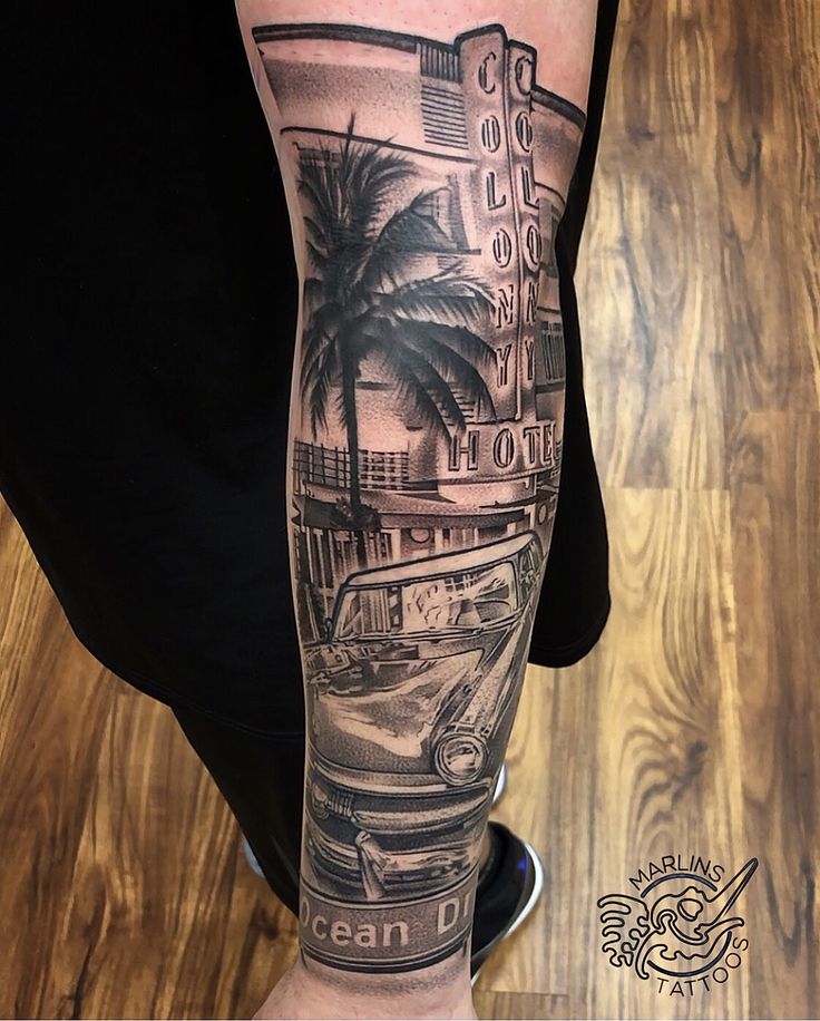 a person with a tattoo on their arm that has cars and palm trees in the background