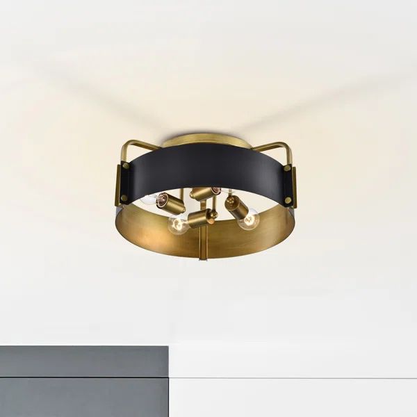 an overhead view of a modern ceiling light with black and gold trim on the top