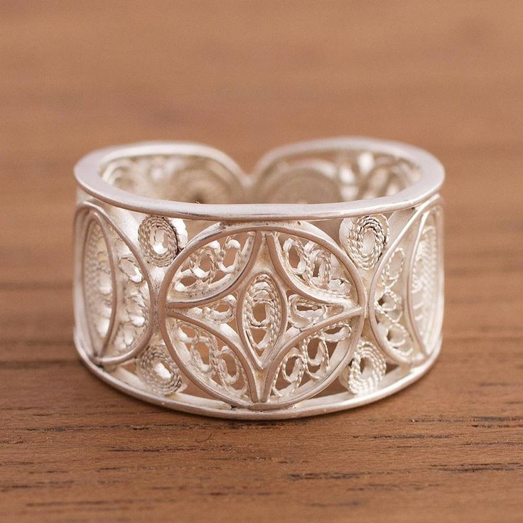 Crafted by hand with intricate sterling silver filigree scrollwork this elegant band ring evokes the beauty of the moon. Peruvian artisan Alfredo Inga designs the ring which accentuated by a combination of finishes. Bohemian Sterling Silver Filigree Ring For Wedding, Ornate Sterling Silver Filigree Ring With Intricate Design, Bohemian Silver Filigree Wedding Ring, Elegant Filigree Toe Ring With Intricate Design, Adjustable Bohemian Engraved Ring With Intricate Design, Bohemian Filigree Open Ring With Intricate Design, Elegant Sterling Silver Filigree Ring With Decorative Band, Bohemian Open Filigree Ring With Intricate Design, Sterling Silver Engraved Open Ring With Intricate Design