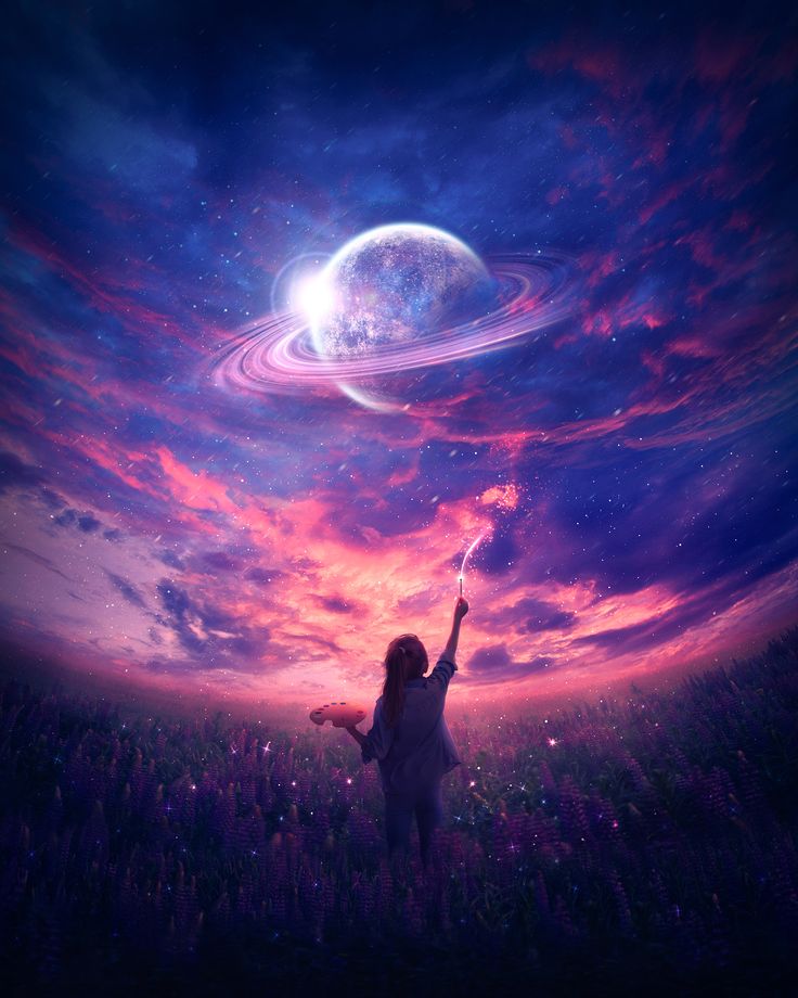 a girl is standing in the grass with her hand up to the stars and planets