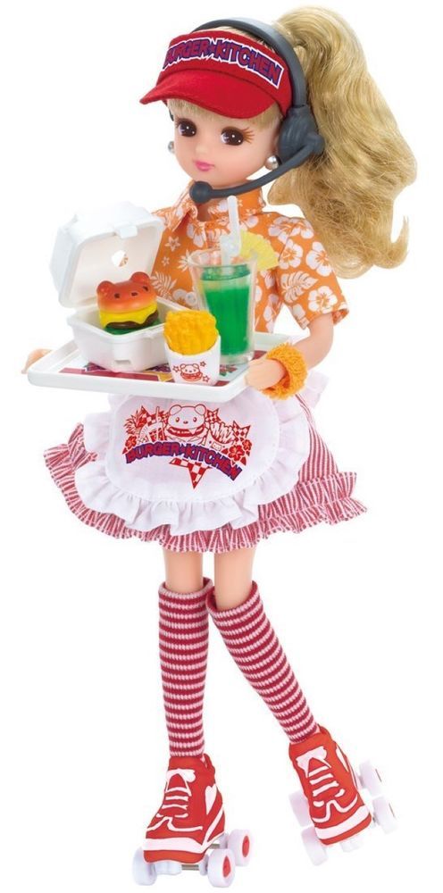 a doll holding a tray with food and drinks on it's lap, while wearing headphones