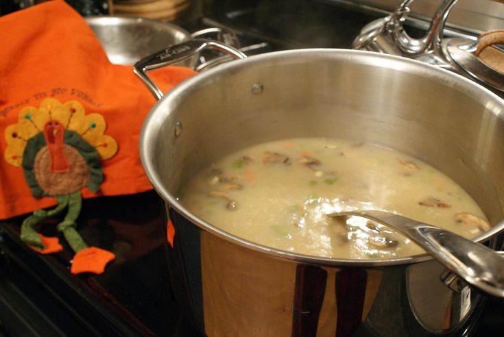 a pot filled with food sitting on top of a stove next to a turkey towel