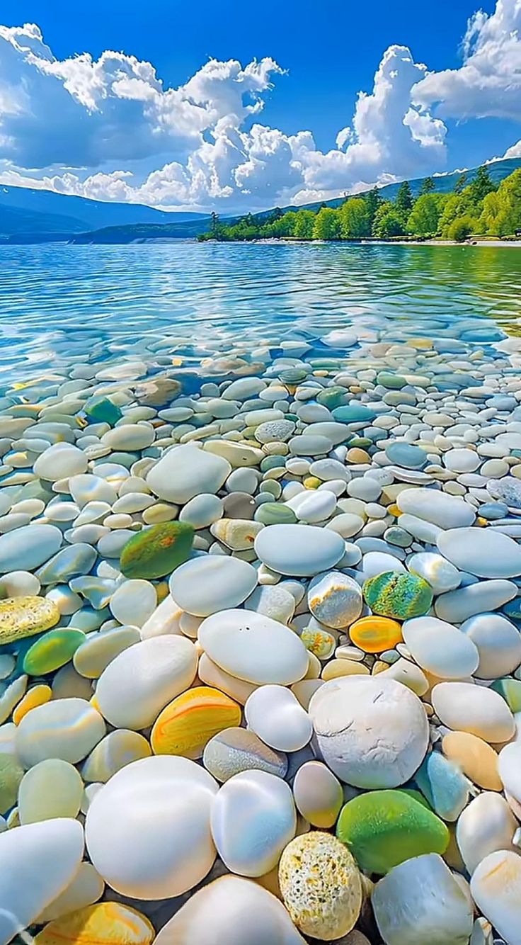 the water is crystal blue and has many rocks in it