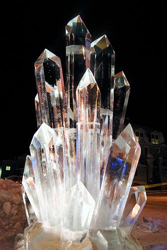 a crystal sculpture sitting on top of a pile of rocks