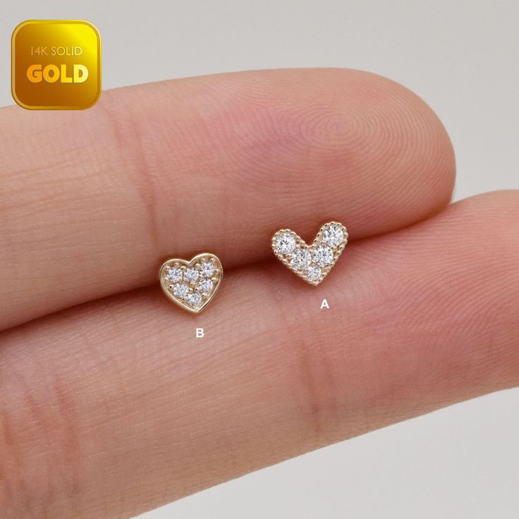 Metal: 14k solid gold, Available Gold color: Yellow gold  Guaranteed Authentic :14k Solid Gold，Not Gold Plated or Gold Filled Stone:  CZ Thickness:0.82mm (20G) Stamp:14k ★Every ear is different, the length of backings that most suitable for your ear will depend on your ear thickness ★Titanium is a very safe metal, so we don't plate it, in order to avoid some people are allergic to the plating material. NOTE The item combined by 14k solid gold and implant grade titanium push in back,  packed in a beautiful Jewelry Box   SHIPPING ADDRESS All the orders will ship to the supplied address through your Etsy Order, Please leave your phone number,will give to carrier for safe deliver. We will not send and replacement parcels due to incomplete or inaccurate address.  PACKING ●Can be Gift packed inc Gold Pierced Heart Earrings Fine Jewelry, Single 14k Gold Heart Earring For Gift, Gold Heart Earrings In Minimalist Style, Fine Jewelry Yellow Gold Piercings For Gift, Gold Heart-shaped Elegant Piercings, Dainty Tiny Gold Heart Earrings, Elegant Gold Heart-shaped Piercings, Elegant Gold Heart Piercings, Gold Heart Jewelry With Internally Threaded Details