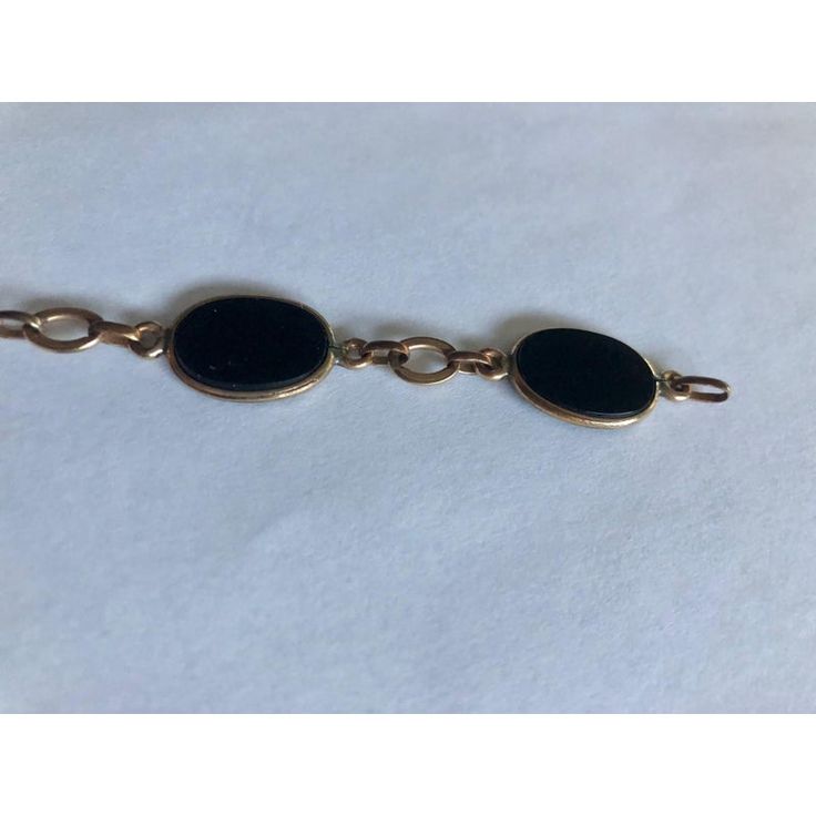 This is part of Chairish’s Fine Jewelry assortment.  This gorgeous 1950s 12K Gold Oval Onyx Link Bracelet has five smooth-sided black onyx stones wrapped in 12K gold and separately by matching chain links. Simply elegant and ready to wear, this link bracelet, which appears to have the Coro mark (illegible), will be a fabulous addition worn alone or stacked with other complementary bracelets for maximum impact.  Dimensions: 7.5" L Condition: Good vintage condition; wear consistent with age. Please see pics for details. Marks: 12KT, Coro(?) Elegant Black Link Jewelry, Classic Black Link Jewelry, Black Link Jewelry For Formal Occasions, Formal Black 14k Gold Bracelets, Formal Black Gold Bracelet, Gold Onyx Bracelet For Formal Occasions, Black 14k Gold Bracelet For Formal Occasions, Vintage Oval Link Bracelet With Polished Finish, Vintage 14k Gold Oval Link Bracelets