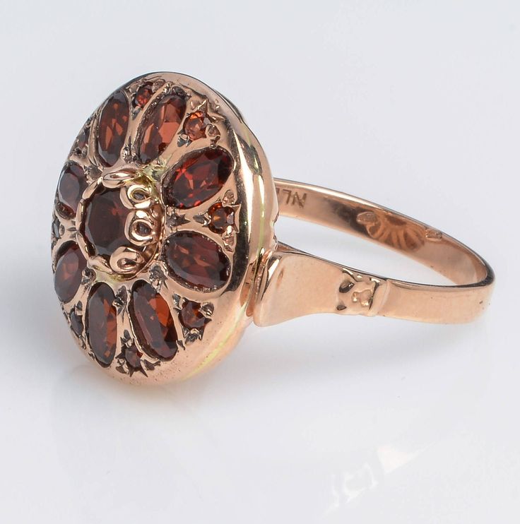 Handmade 14K Rose Gold Ring with Garnet Oval Flower Shape Garnet is a stone of regeneration and energizing it can boost energy. It is said to be stabilizing in that it can bring order to chaos whether internal or external. Details and Measurements: ► 14 Karat Rose Gold ► Size 7.5 (select your size) ► Central Garnet 5 mm ► 8 Garnet stones 5x3 mm ► 8 Garnet stones 1.75 mm ► Total Weight 7.7 gr All items are Handmade, I pay a lot of attention to every piece. All of my items are hand crafted in Kisu Luxury Rose Gold Garnet Jewelry, Victorian Multi-stone Ruby Ring, Yellow Gold Garnet Multi-stone Ring, Multi-stone Garnet Ring In Yellow Gold, Victorian 14k Gold Cluster Ring With Gemstone, Antique Ruby Ring With Multi-stone, Heirloom 14k Gold Flower Ring With Gemstone, Heirloom Oval Flower Ring Hallmarked, Yellow Gold Garnet Ring With Rose Cut Diamonds