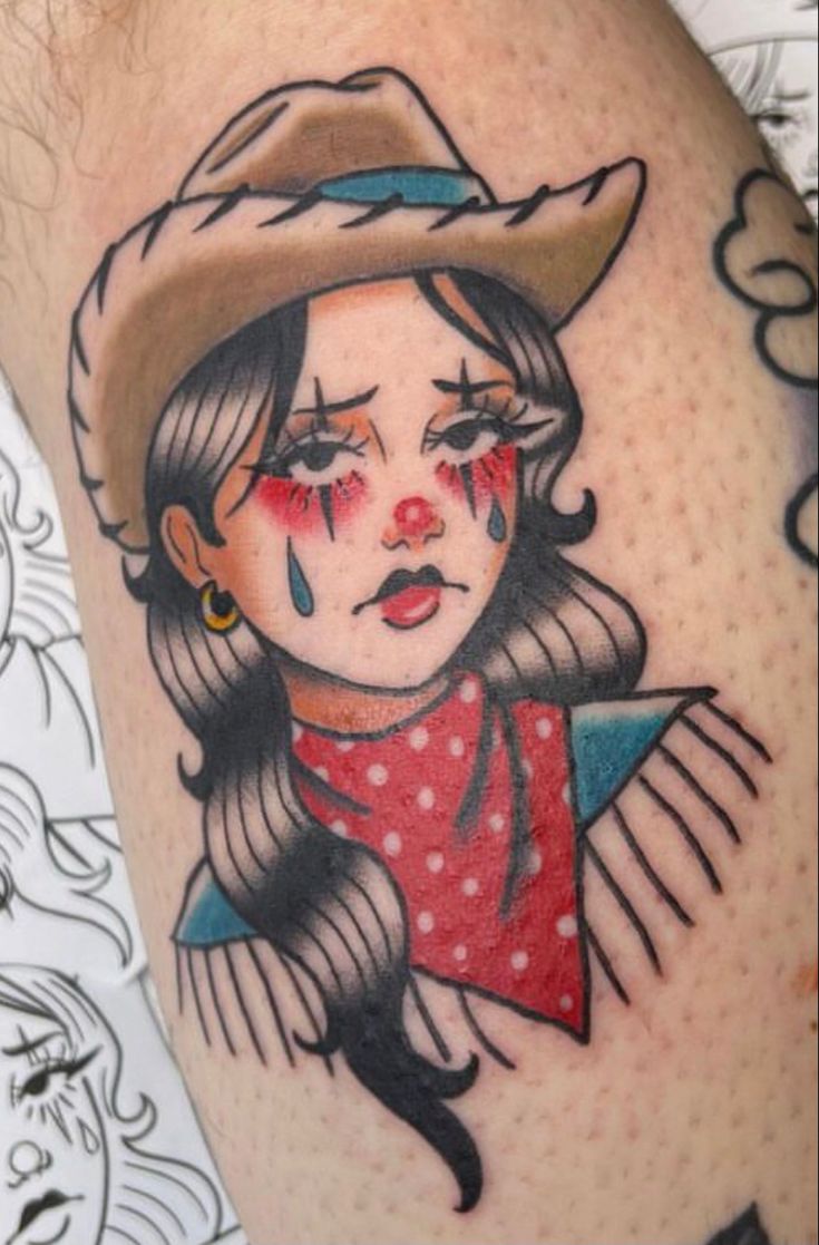 a tattoo with a girl wearing a cowboy hat on it's head and red eyes