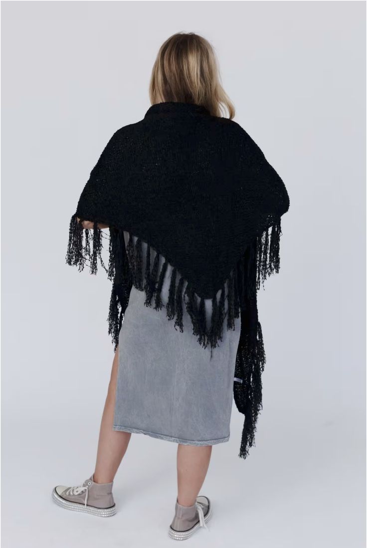 Drape yourself in the Moon Shadows Ruana Wrap and feel stylishly boho from day to night! This cozy-knit wrap features a loose and flowy silhouette, a beautiful triangular shape, and adorable tassel trim for a unique and versatile look. Infuse your wardrobe with some boho flair! Details: One size: 33 1/2"W x 86"L 100% Acrylic Hand wash cold, Lay flat to dry Import Black Bohemian Shawl For Fall, Black Bohemian Poncho Shawl, Winter Bohemian Black Wrap, Bohemian Black Winter Wrap, One Size Knit Poncho With Fringe, Black One Size Bohemian Wrap, One Size Black Bohemian Wrap, Bohemian Black Wrap One Size, Black Bohemian Wraps One Size