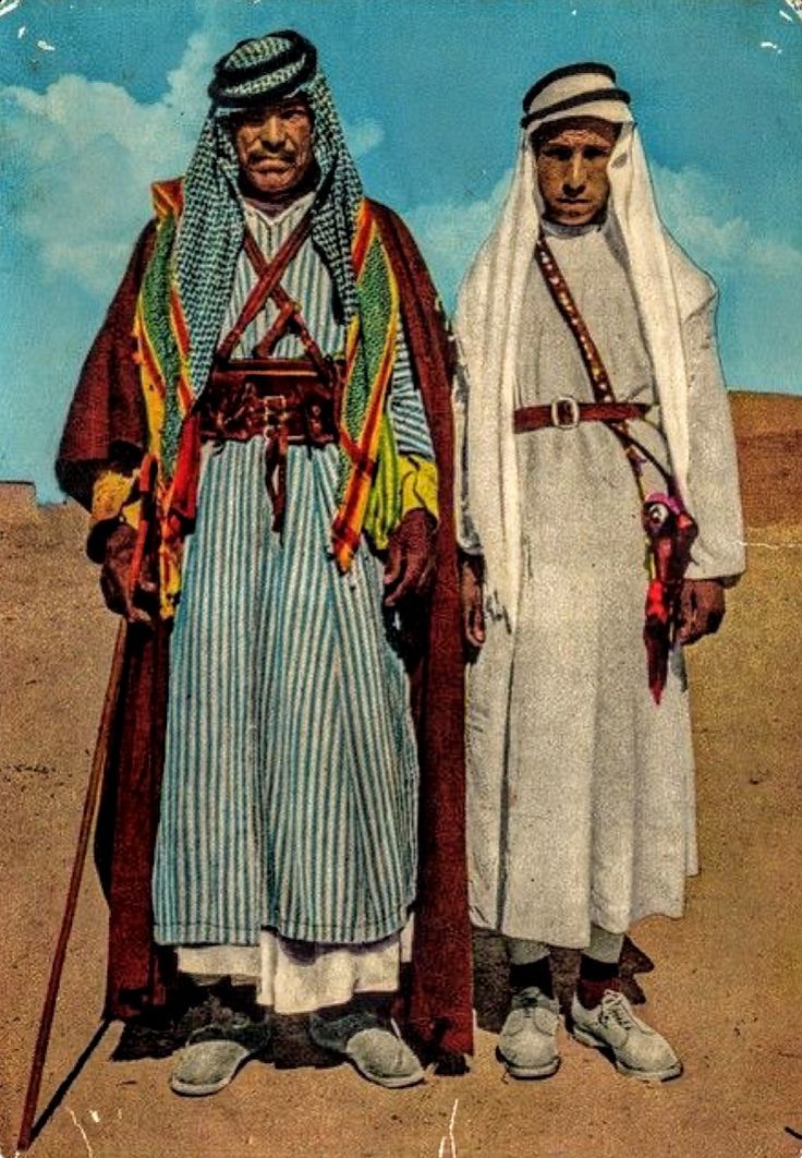 two men standing next to each other in the desert