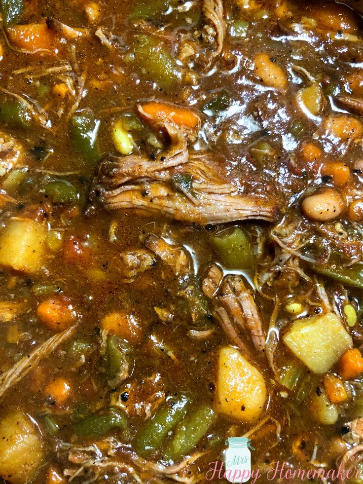 meat and vegetable soup in a pot with spoon