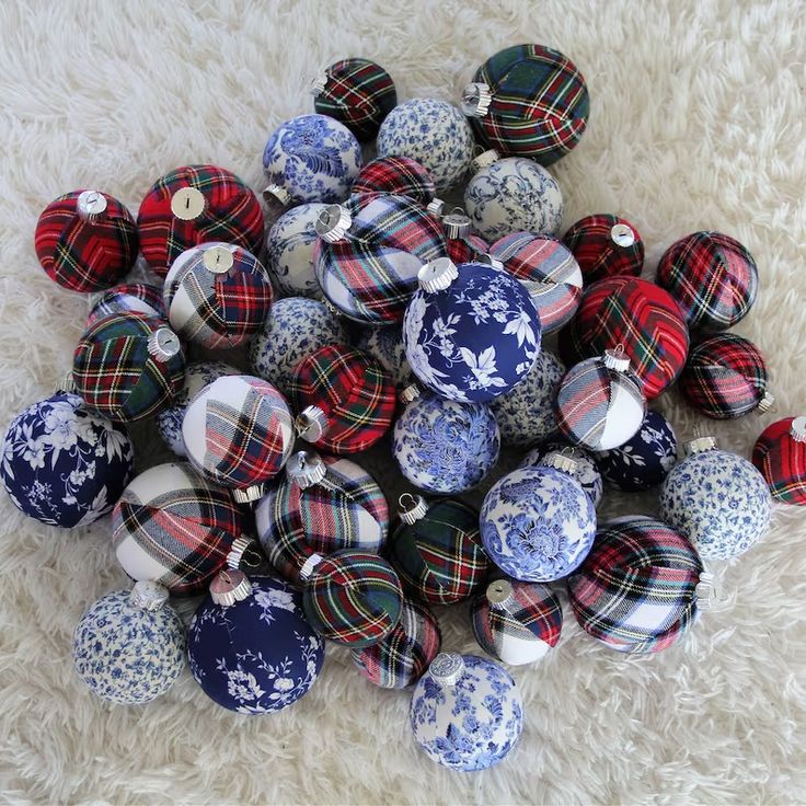 a pile of blue and white ornaments sitting on top of a fluffy white floor next to each other