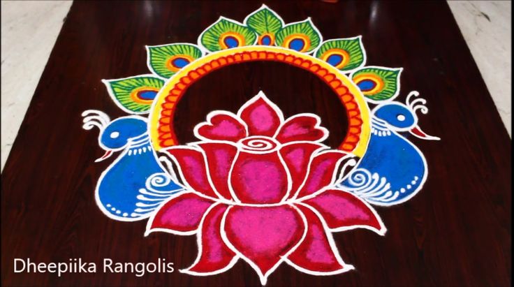 an artistically painted flower and peacock design on a wooden table with the words deepika rangolii written below it