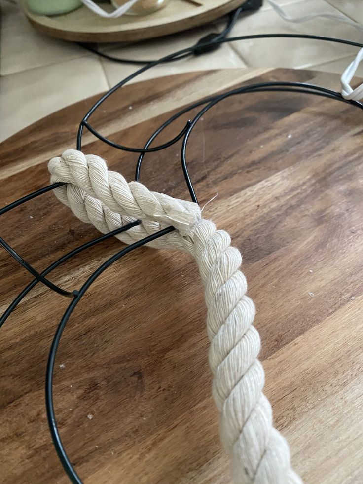 a white rope is on top of a wooden table