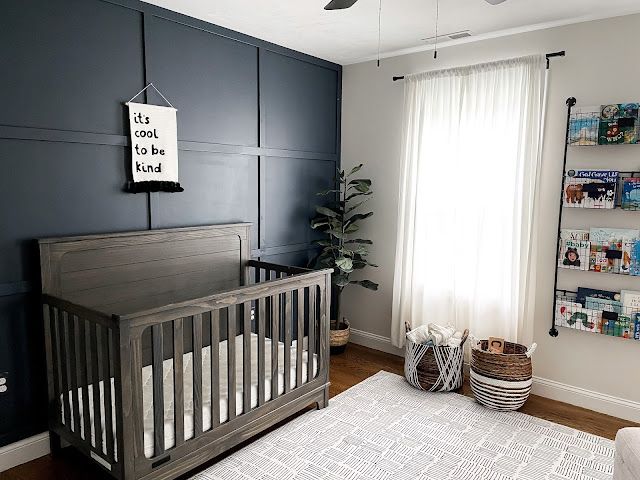 a baby's room with blue walls and white carpet