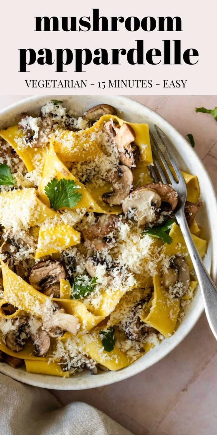 a white bowl filled with pasta covered in mushrooms and parmesan cheese