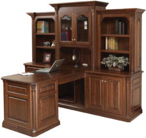 an office desk with bookcases and a laptop on it's desk top