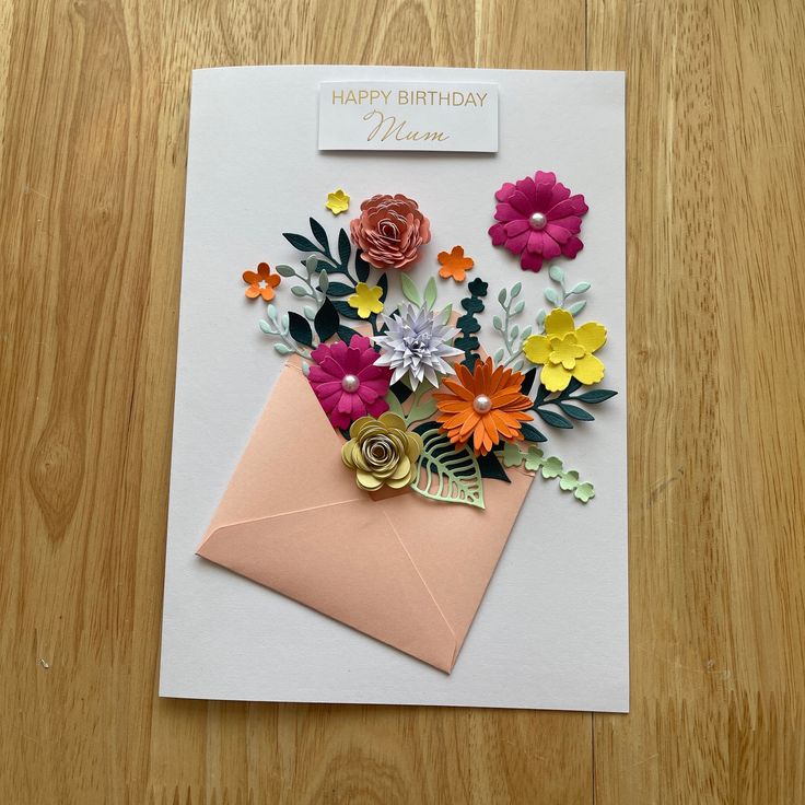 a birthday card with flowers and a envelope