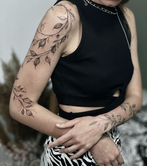 a woman with tattoos on her arm and chest