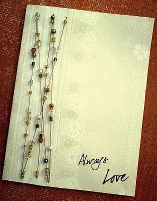 there is a card with some beads on it and the words always love are written in black ink