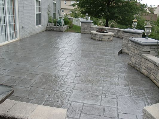 an outdoor patio with stone steps and seating area