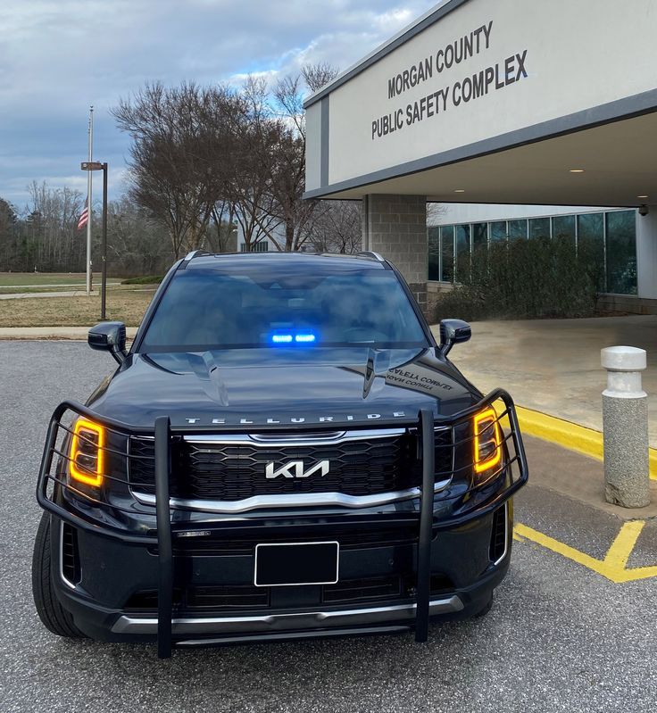 a police car is parked in front of the urban county public safety command complex building