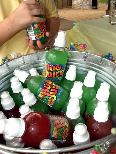 a bucket filled with lots of bottles of juice