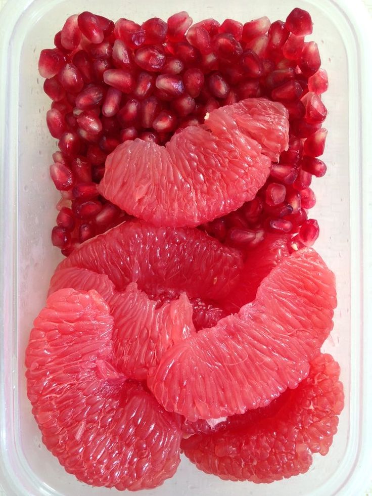 grapefruit and pomegranate in a plastic container