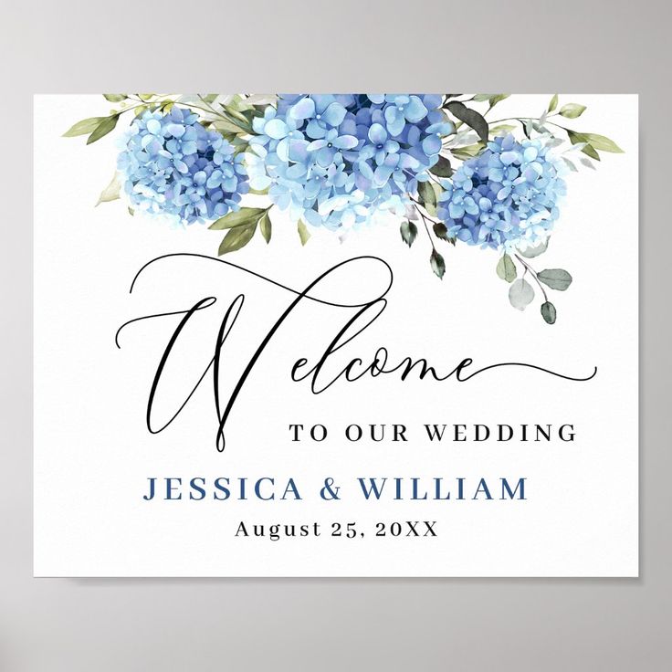 a welcome sign with blue flowers and greenery on the front, in white background