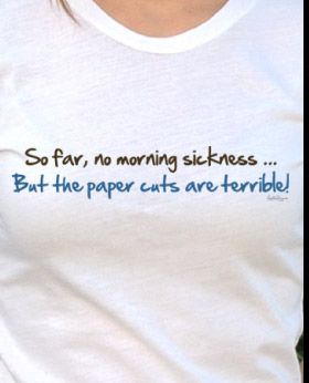 a woman wearing a t - shirt that says, so far, no morning sicknesss but the paper cuts are terrible