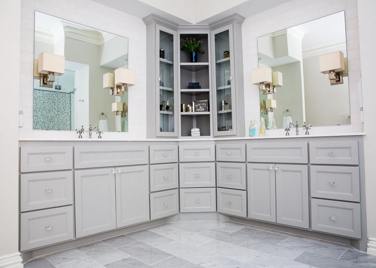 a large bathroom with two sinks and mirrors