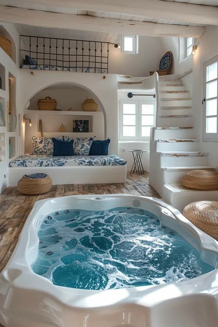 a large jacuzzi tub sitting in the middle of a living room next to stairs