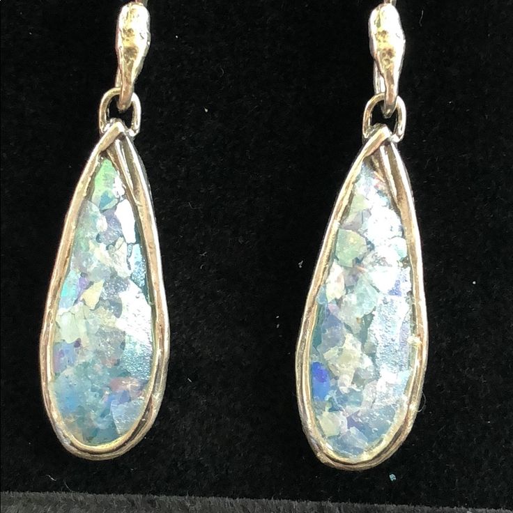 This Is A Pair Of Delicate Teardrop Shaped Roman Glass Earrings. They Are Surrounded In Lightly Hammered .925 Sterling Silver. These Earrings Come With A Certificate Of Authenticity Regarding The Roman Glass. It Is Definitely Art For Your Earlobes! I Think These Would Look Amazing With A Crisp White Shirt, And A Pair Of Your Favorite Denim Jeans. Silver Teardrop Pendant Earrings Fine Jewelry, Fine Jewelry Silver Teardrop Pendant Earrings, Sterling Silver Teardrop Pendant Earrings For Party, High Luster Silver Dangle Jewelry, Silver Teardrop Sparkling Earrings, Sparkling Silver Teardrop Earrings, Formal High Luster Sterling Silver Earrings, Silver Drop Earrings With High Luster, Silver Teardrop Pendant Earrings