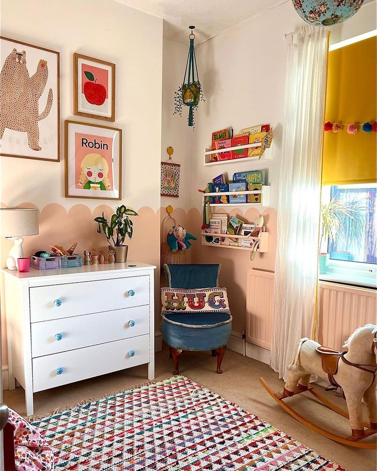 a child's room with toys and artwork on the walls, including a rocking horse