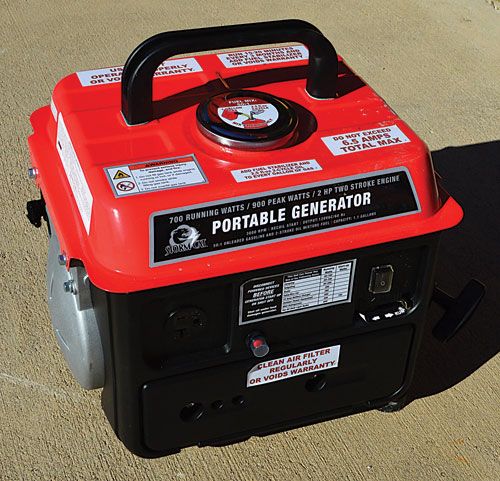 a red and black portable generator on the ground