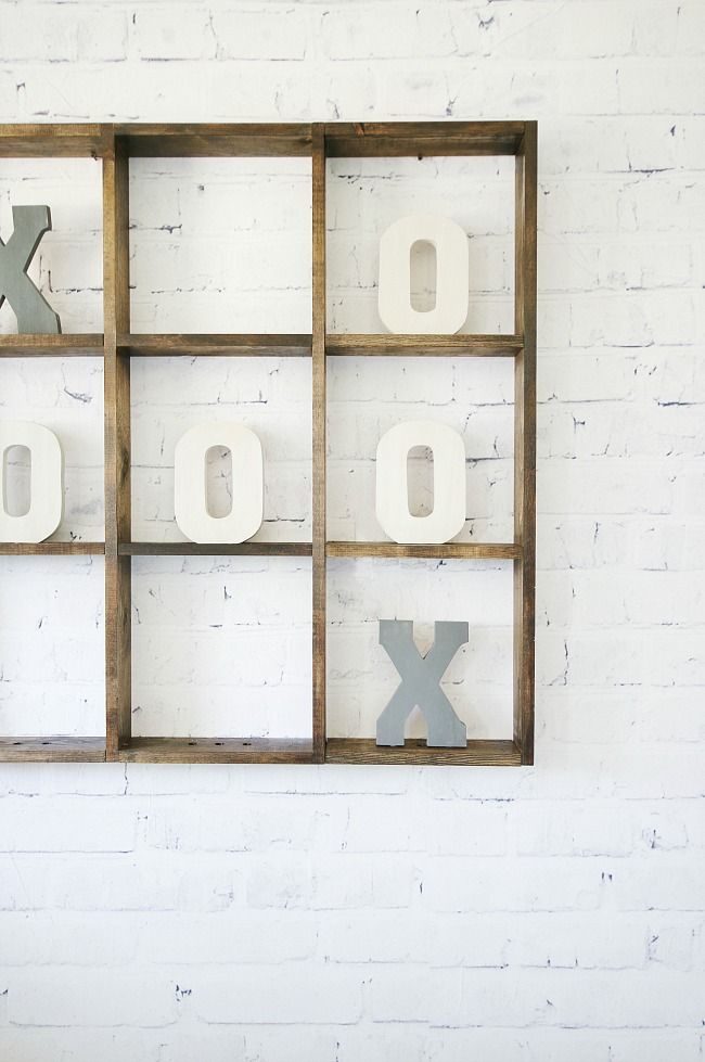 the letters are made out of wood and have been placed in an open window frame