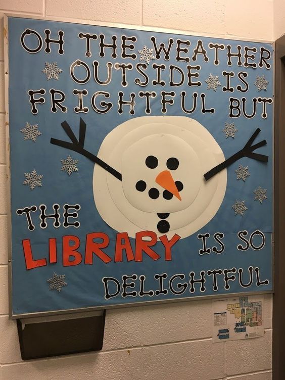 a library sign with a snowman made out of paper and some words on it