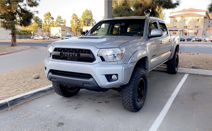 a silver toyota truck parked in a parking lot