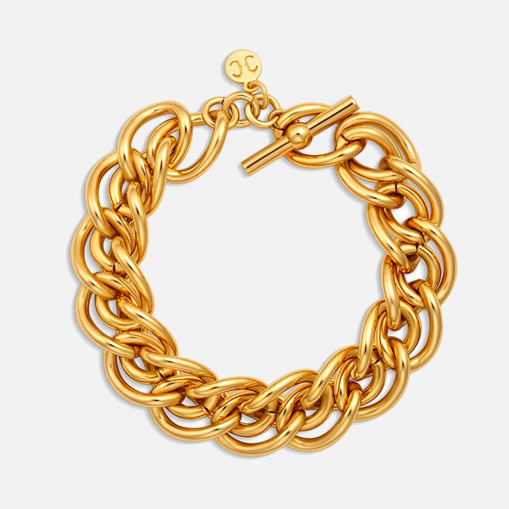 The Christina Caruso Braided Chain Bracelet, is a statement piece that exudes both elegance and substance. Crafted with meticulous attention to detail, this chunky bracelet is dipped in luxurious 14k gold, offering a lustrous finish that catches the eye. Despite its substantial weight, it maintains a comfortable wearability, striking the perfect balance between presence and comfort. Secured with a sophisticated T-bar closure embellished with the brand's iconic logo charm, it's the ultimate acces Luxury Chunky Chain Bracelet, Formal Chunky Chain Bracelet, Chunky Chain Yellow Gold Bracelet, Formal Yellow Gold Bracelet With Chunky Chain, Formal Yellow Gold Chunky Chain Bracelets, Gold Chunky Chain Link Bracelet, Classic Gold-tone Bracelet With Chunky Chain, Classic Gold-tone Chunky Chain Bracelet, Gold Plated Oyster Bracelet Chain